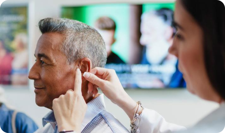 Beltone specials examining patients ear