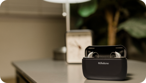 The Beltone Achieve hearing aid pictured inside the holding case.