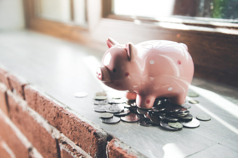 Piggy bank with surrounding coins