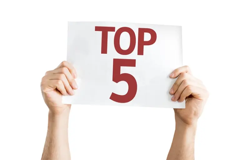 Person holding up a paper with text "Top 5"