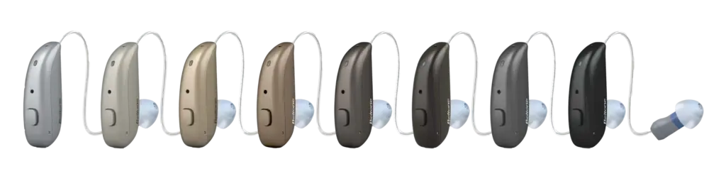 Eight Beltone hearing aids displayed in various colors, from a light silver to darker brown and gray. 