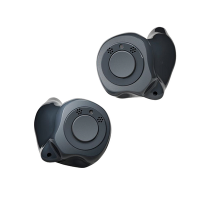 Two small in-ear hearing aids are made from black and gray plastic components, each with a button on the outside.